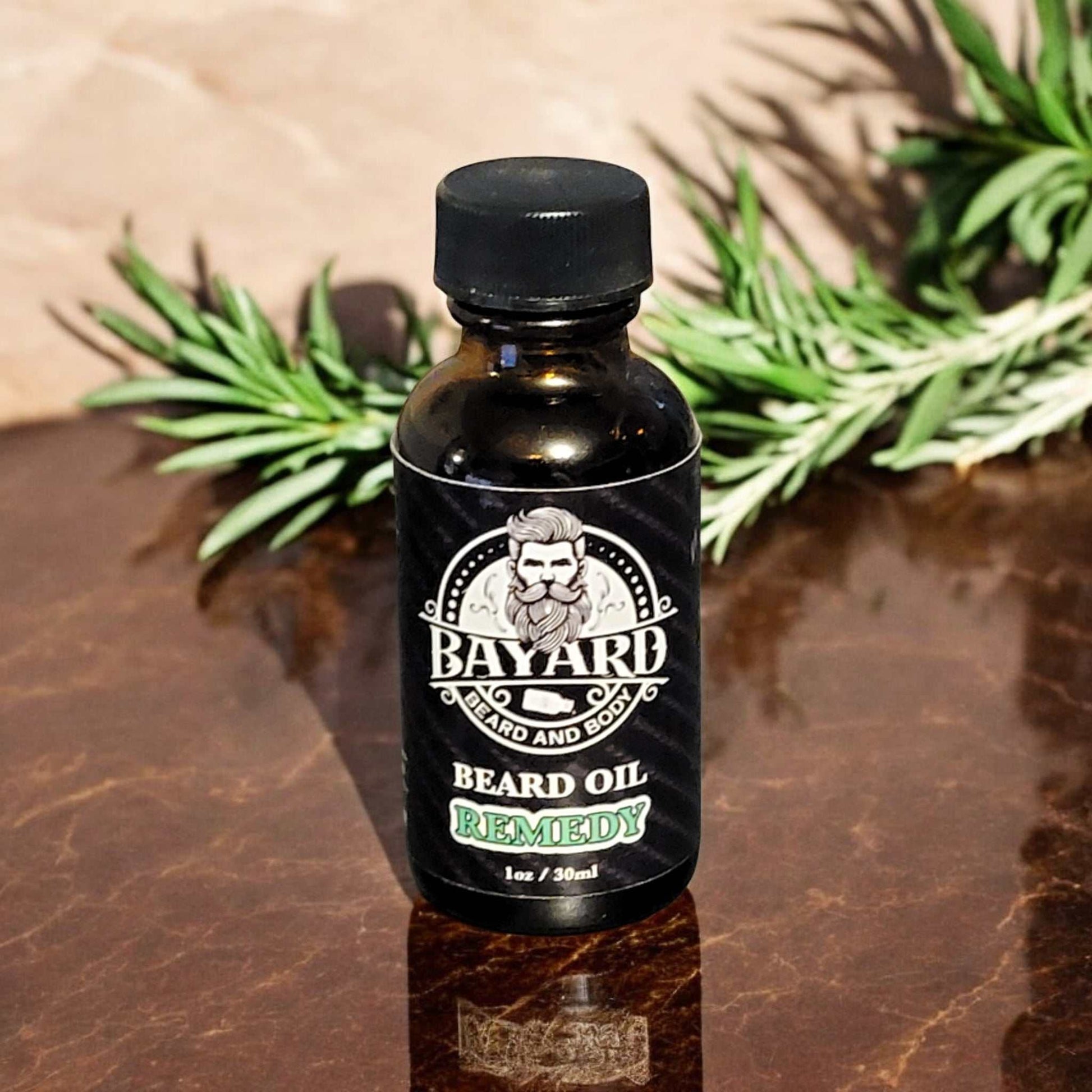 Remedy Beard Oil on a table with a rosemary plant