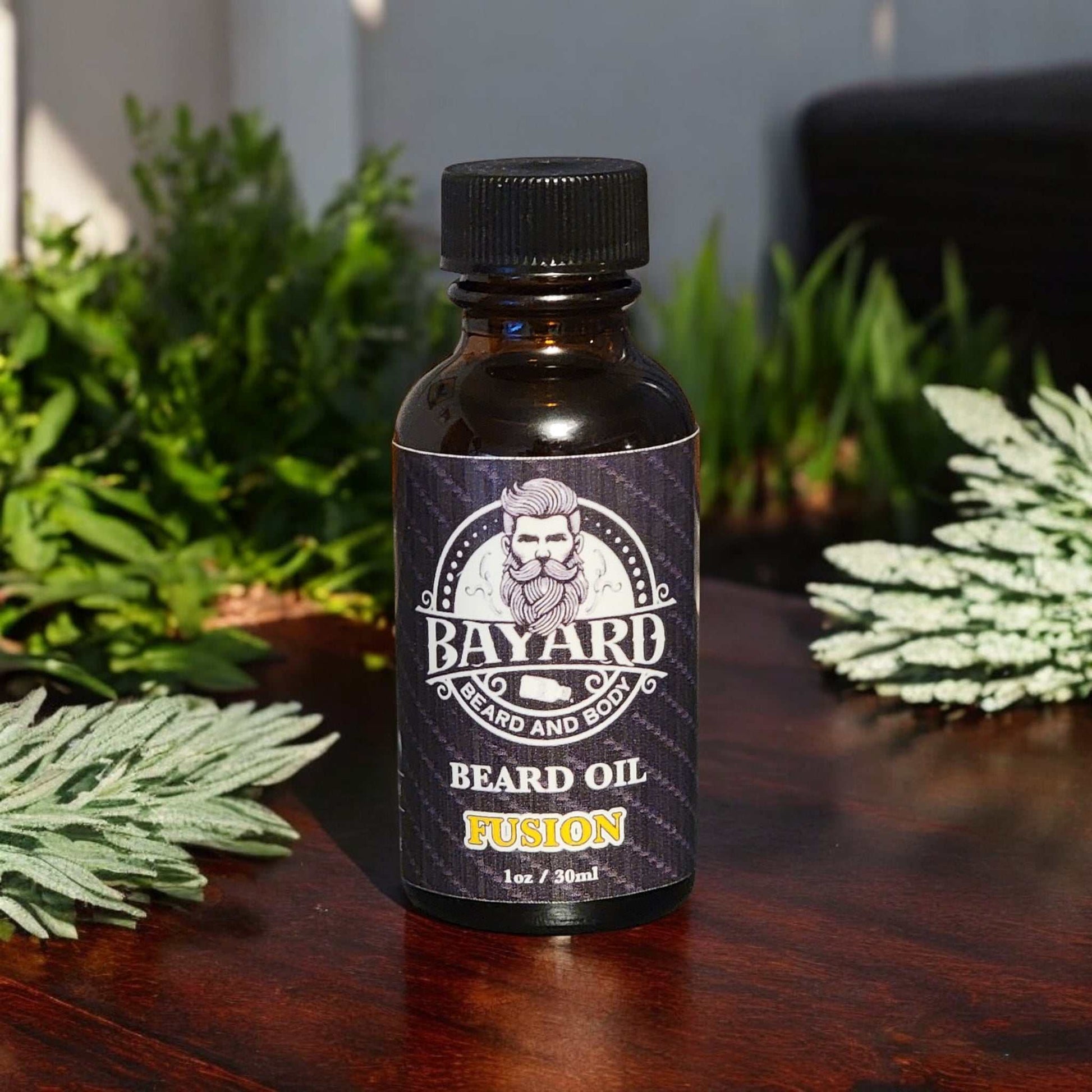 Fusion Beard Oil on a table with lemongrass and sage in the background 