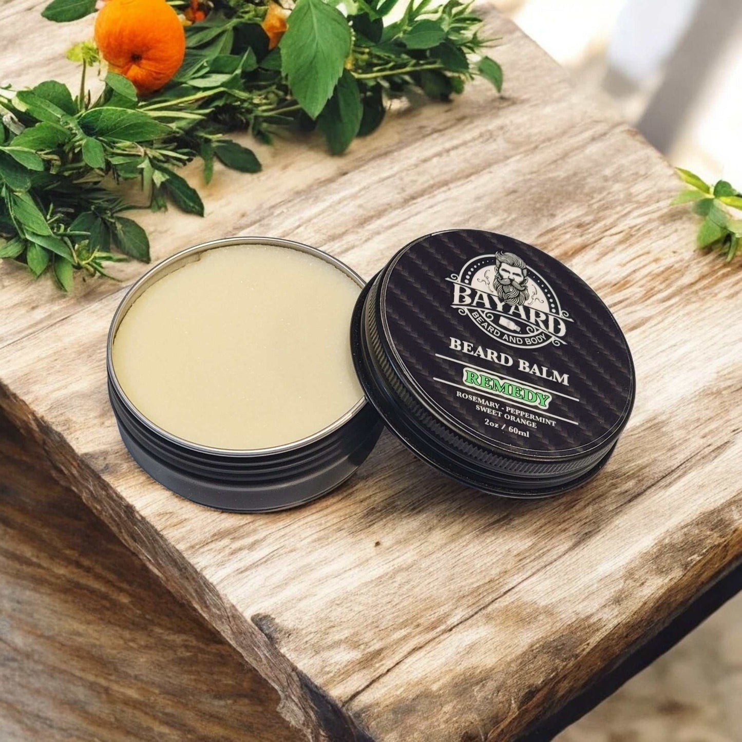 Remedy Beard Balm On a table with Rosemary and Oranges